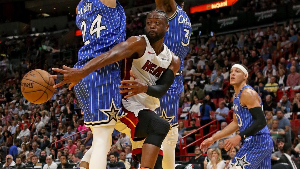 Miami Heat guard Dwyane Wade (3) looks to pass against Orlando Magic center Khem Birch (24) Terrence Ross (31) and Aaron Gordon (00) in the second quarter of an NBA basketball game at the AmericanAirlines Arena on Tuesday, March 26, 2019 in Miami.