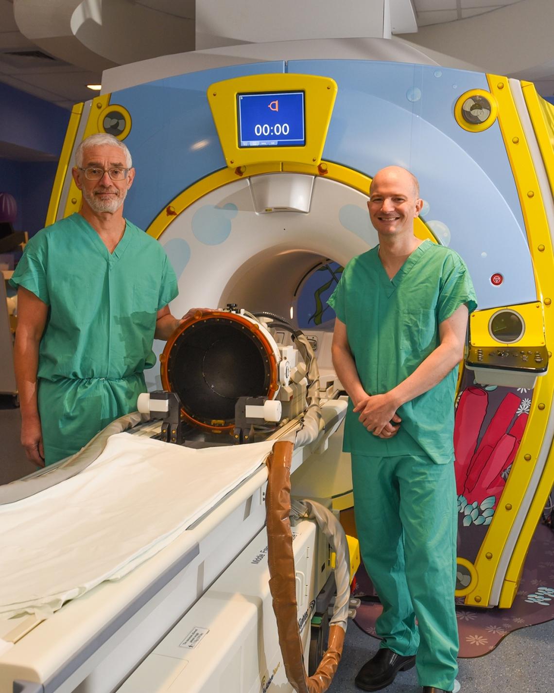 Dr. John Ragheb and Dr. Ian Miller with the INSIGHTEC MRI-guided focused ultrasound machine at Nicklaus Children’s Hospital. 