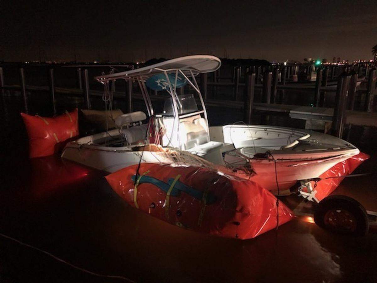 A center console boat with a large gash on its hull sits on a trailer Monday night, Jan. 4, 2021. The vessel was one of two involved in a collision off Key Biscayne that night.