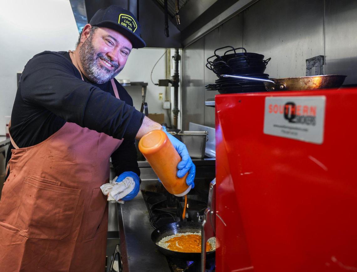 Jorgie Ramos prepares smoked paella at Bar Bella in South Miami.