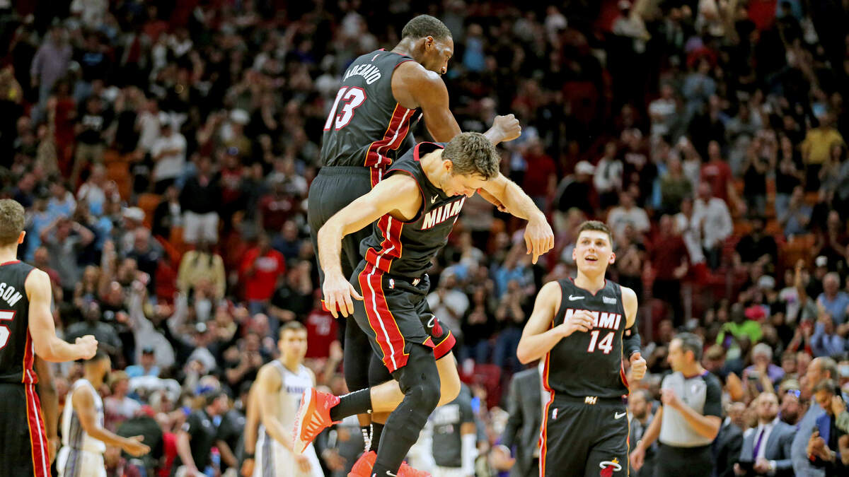 Miami Heat Goran Dragic (7) and Bam Adebayo (13) celebrate after scoring a points at the end of regulation to put the Heat into overtime with the Sacramento Kings at the AmericanAirlines Arena in Miami, Florida, Monday, January, 20, 2020.