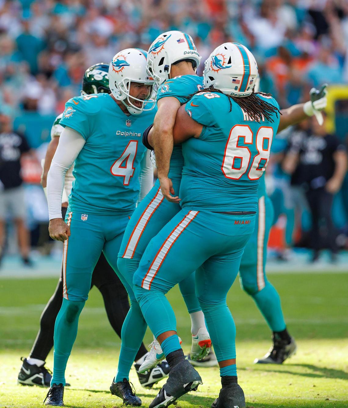 Miami Dolphins place kicker Jason Sanders (7) celebrate with teammates Thomas Morstead (4) and Robert Hunt (68) after kicking the winning field goal during fourth quarter of an NFL football game against the New York Jets at Hard Rock Stadium on Sunday, January 8, 2023 in Miami Gardens, Florida.