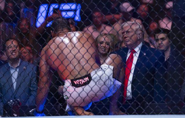 Paulo Costa of Brazil talks with President Donald Trump after his light heavyweight bout against Azamat Murzakanov of Russia at UFC 327 at the Kaseya Center on Saturday, April 11, 2026, in downtown Miami, Fla.