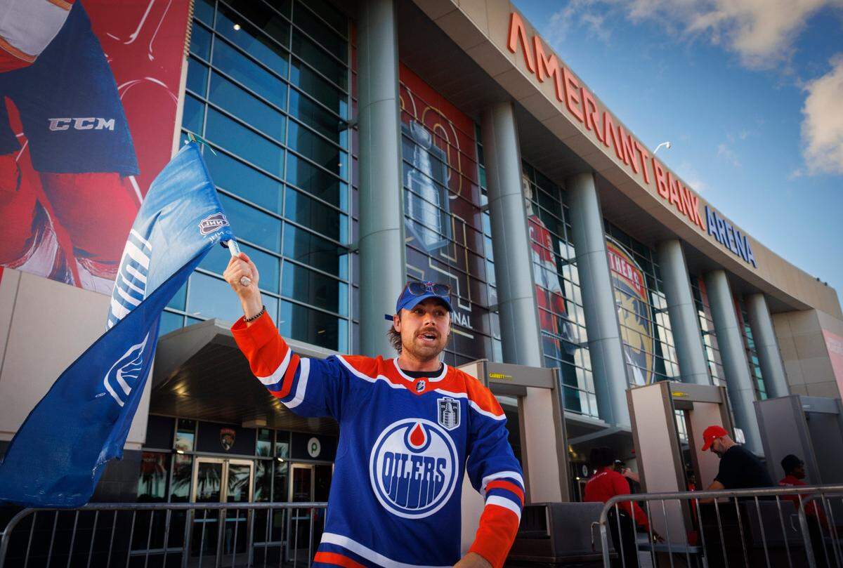Derek Kesseler waves a Edmonton Oilers flag in front of the arena before Game 5 of the NHL Stanley Cup Final