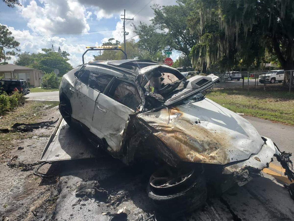 A totaled Lamborghini was put on a tow truck following the fiery crash