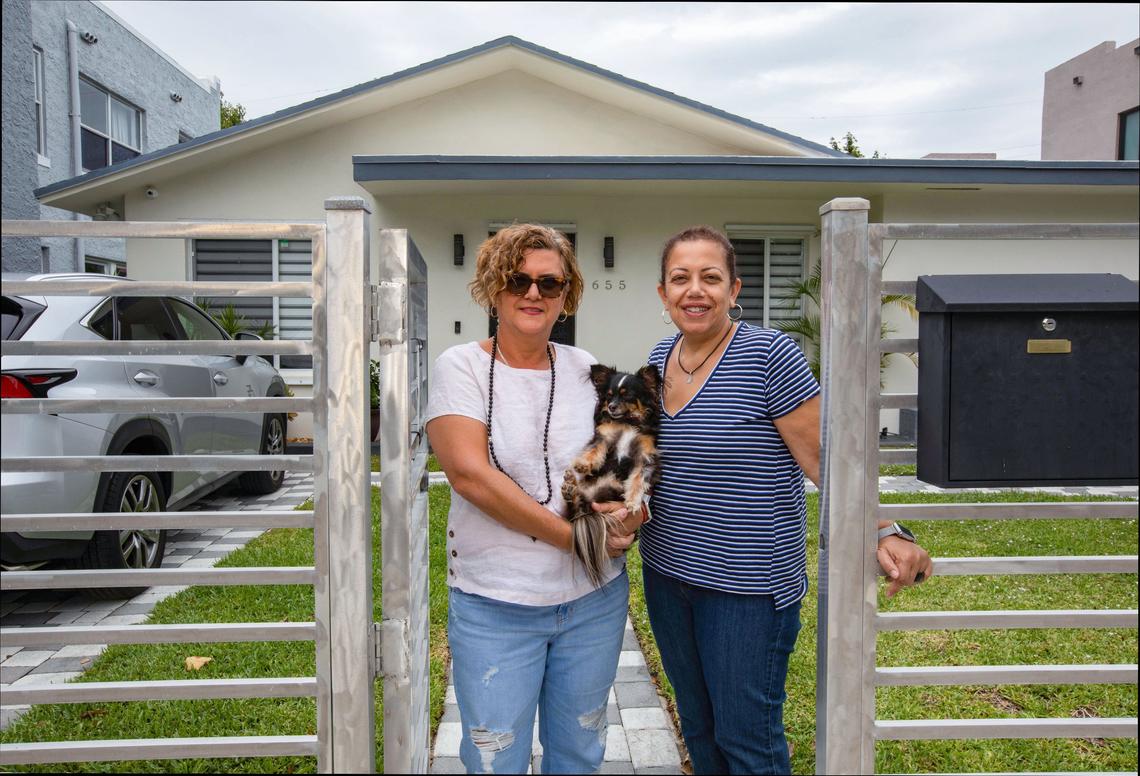 Abbie Cuellar and her partner, Delsa Bernardo, stand in front of their home in Miami along with their dog, Lolita, on April 20, 2019.