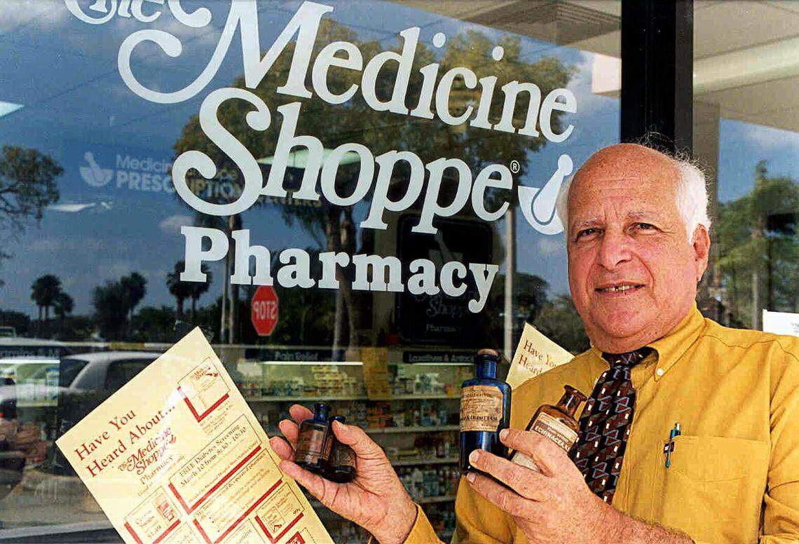 Outside Cooper City’s Medicine Shoppe in 1999, owner-pharmacist Philip Schutzer shows off a few of the antique medicine bottles he collects.