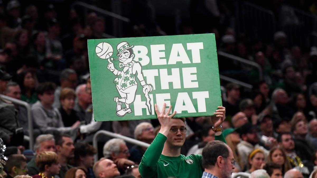 A member of the Boston Celtics entertainment team holds a sign during the second half in game one of the first round for the 2024 NBA playoffs against the Miami Heat at TD Garden.