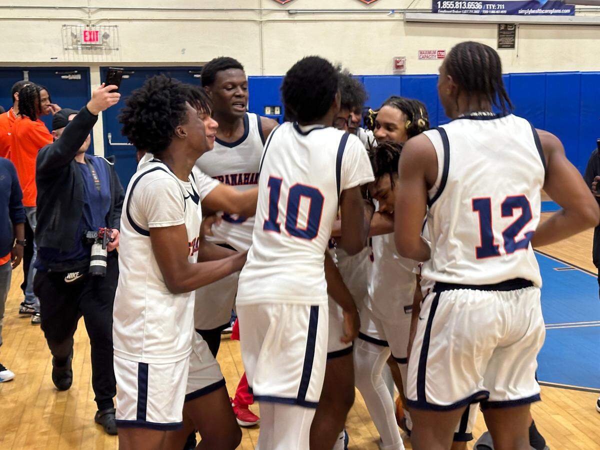 Stranahan boys’ basketball players celebrate after beating Miami St. Brendan 72-61 in the Region 4-4A championship game on Thursday at the Dragons’ home gym in Fort Lauderdale, Fla.