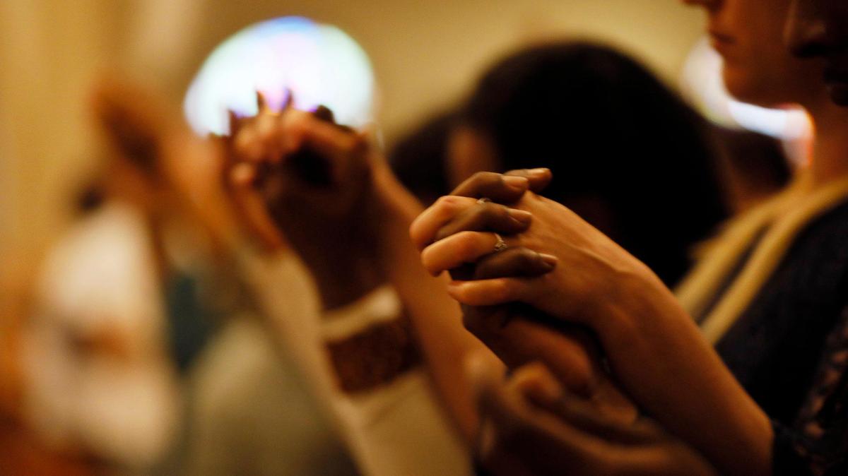 Parishioners pray as Archbishop Wenski celebrates the Liturgy of the Lord’s Passion at The Cathedral of St. Mary in Miami.