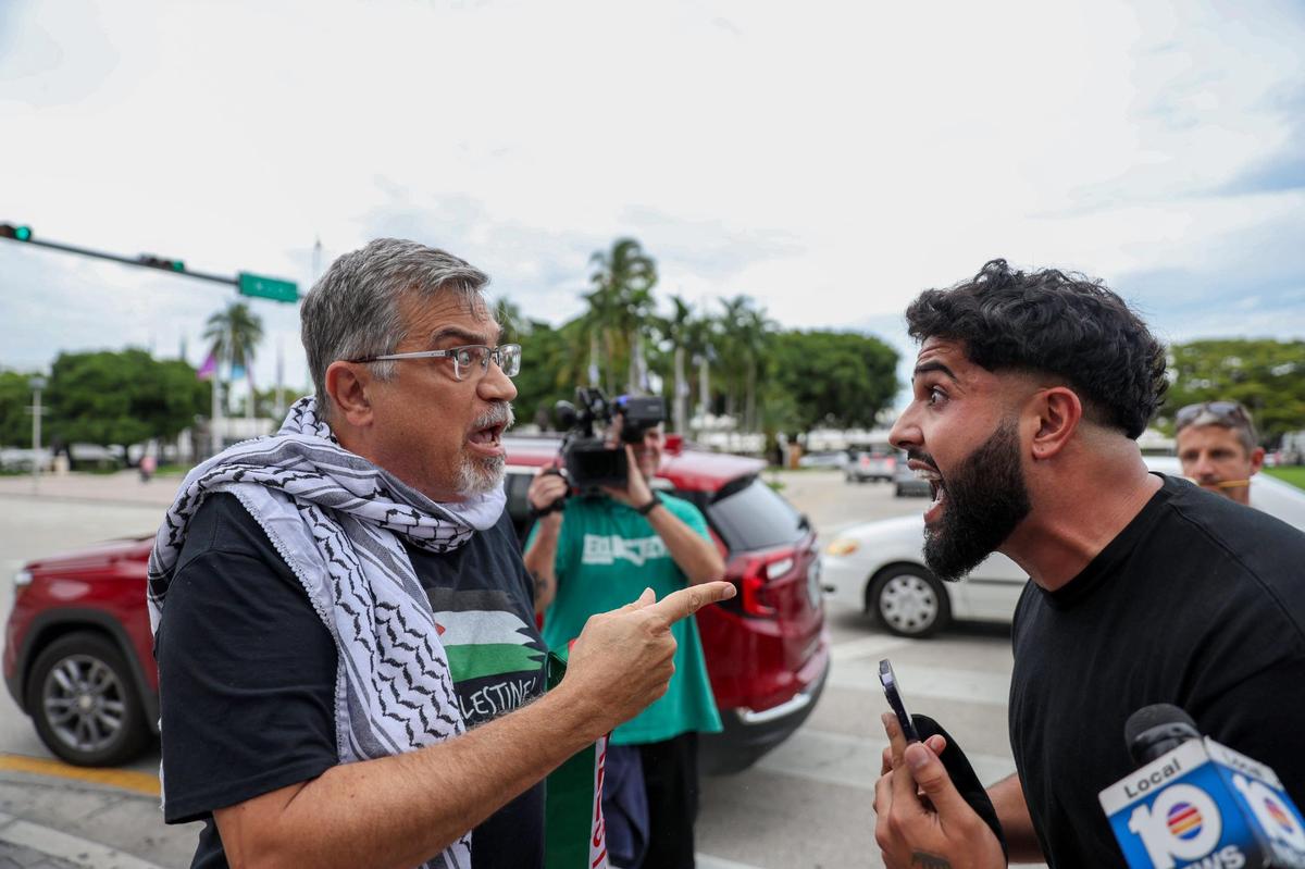 A pro-Palestinian activist, left, argues with a pro-Israel activist during a rally in support of Palestinian in Gaza during the conflict between Israel and Hamas near the Torch of Friendship at Bayfront Park in Miami, Florida, on Friday Oct 13, 2023.