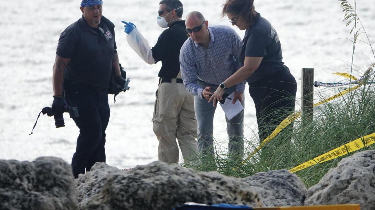 Fort Lauderdale Police and Broward County Medical Examiners work the scene where two bloody bodies were discovered on the beach at the end of Oakland Park Blvd., at the Galt Ocean Mile in Fort Lauderdale, Tuesday, June 9, 2020.