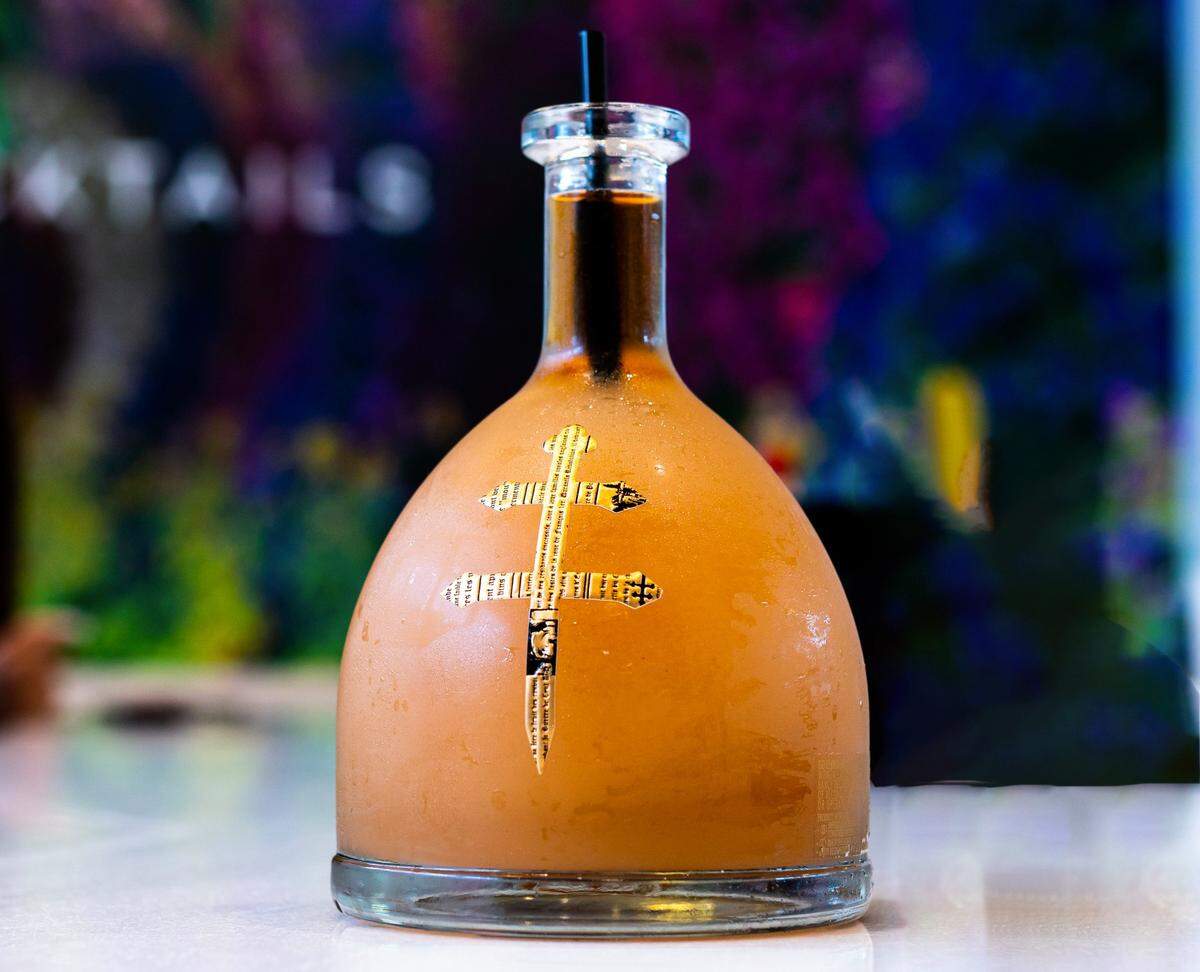 Peach D’usse Frose, a frozen peach drink that comes in a bottle for the table at Kitchen + Kocktails.