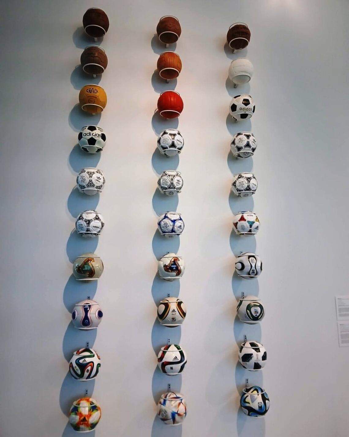 Especially visible in the display are World Cup soccer balls produced by Adidas, stretching from the early leather era to highly engineered contemporary designs.