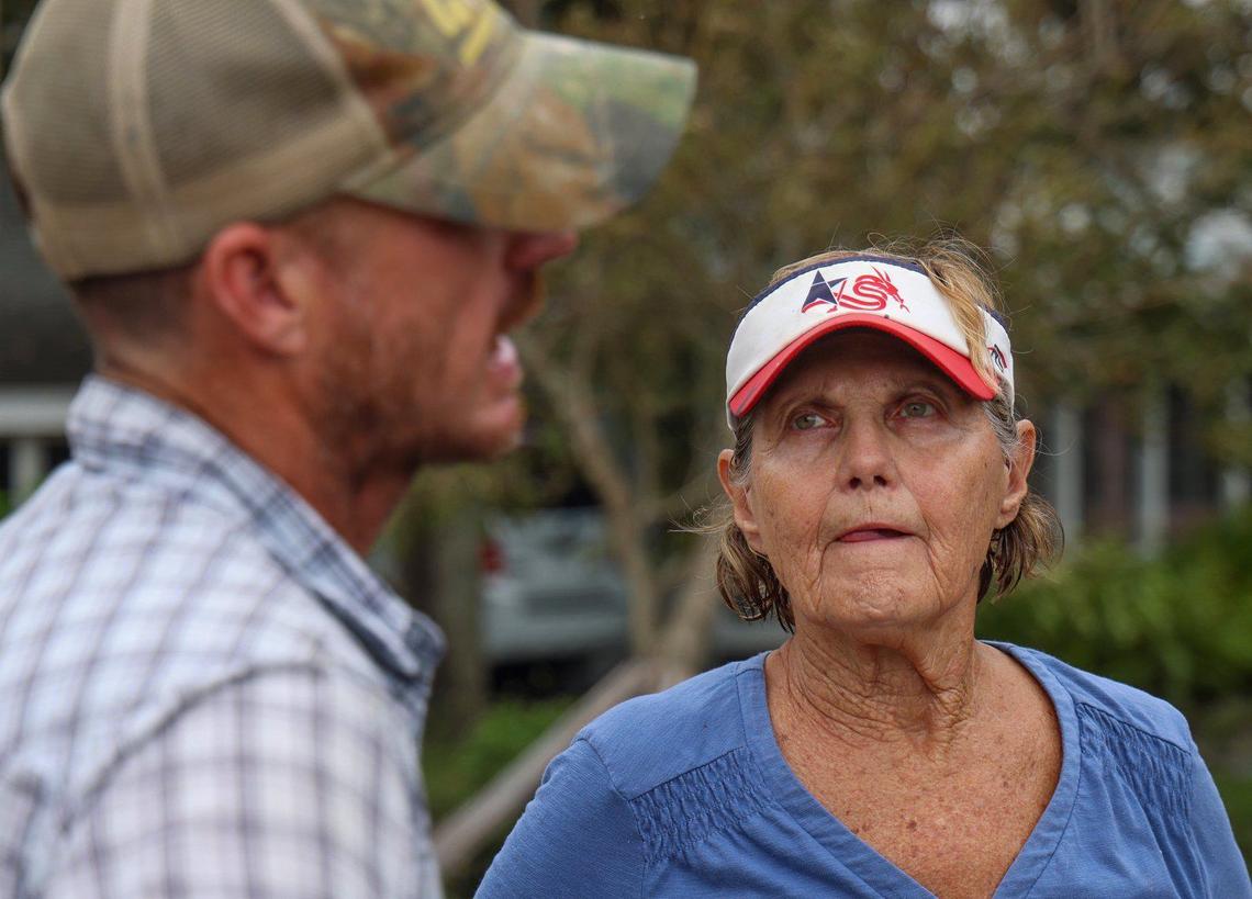 Hurricane Milton’s storm surge moved and damaged boats, cars, and devastated homes not built up to code. With the help of her grandson, James Kirby, 38, left, Marilyn Gladish, 83, cleaned and sorted her belongings and is grateful for bringing her home up to code which reduced her lost and the cost of flood insurance on Friday, October 11, 2024, in Port Charlotte, Florida.