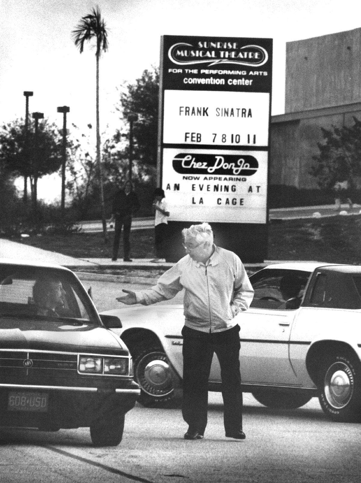 A parking employee at Sunrise Musical Theatre turns away patrons after Frank Sinatra concert cancellation in 1985.