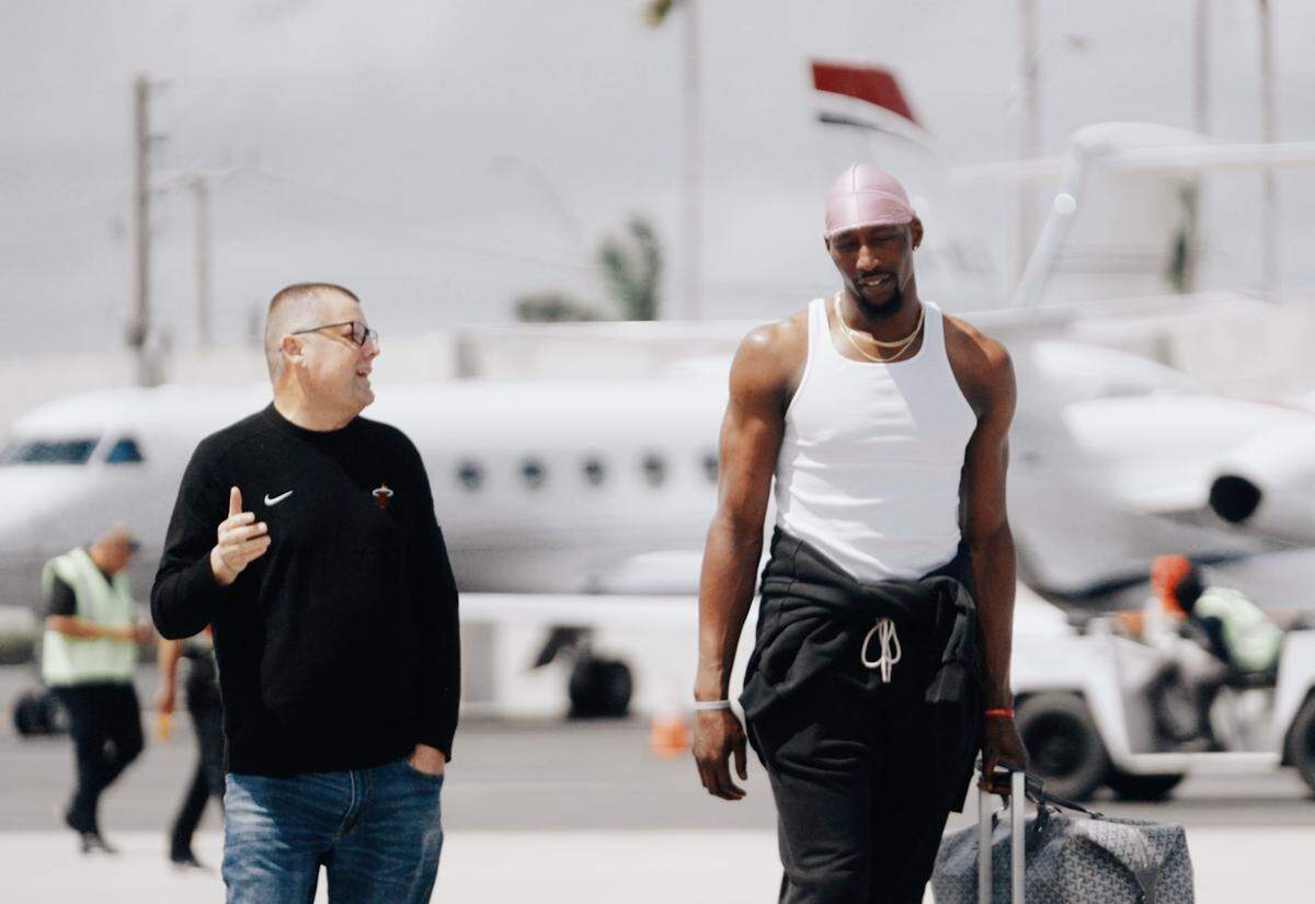 Miami Heat director of team operations Rob Pimental walks alongside Heat center Bam Adebayo.