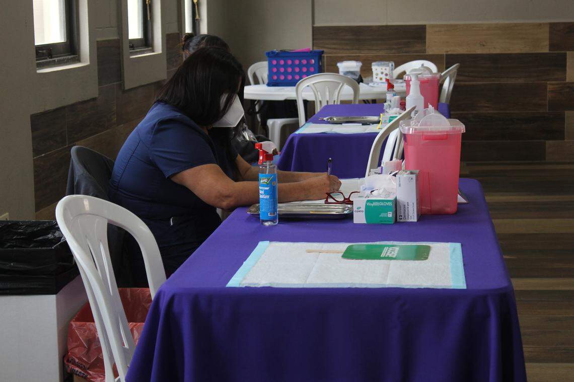 A nurse prepares for the next person she will vaccinate in Añasco, Puerto Rico.