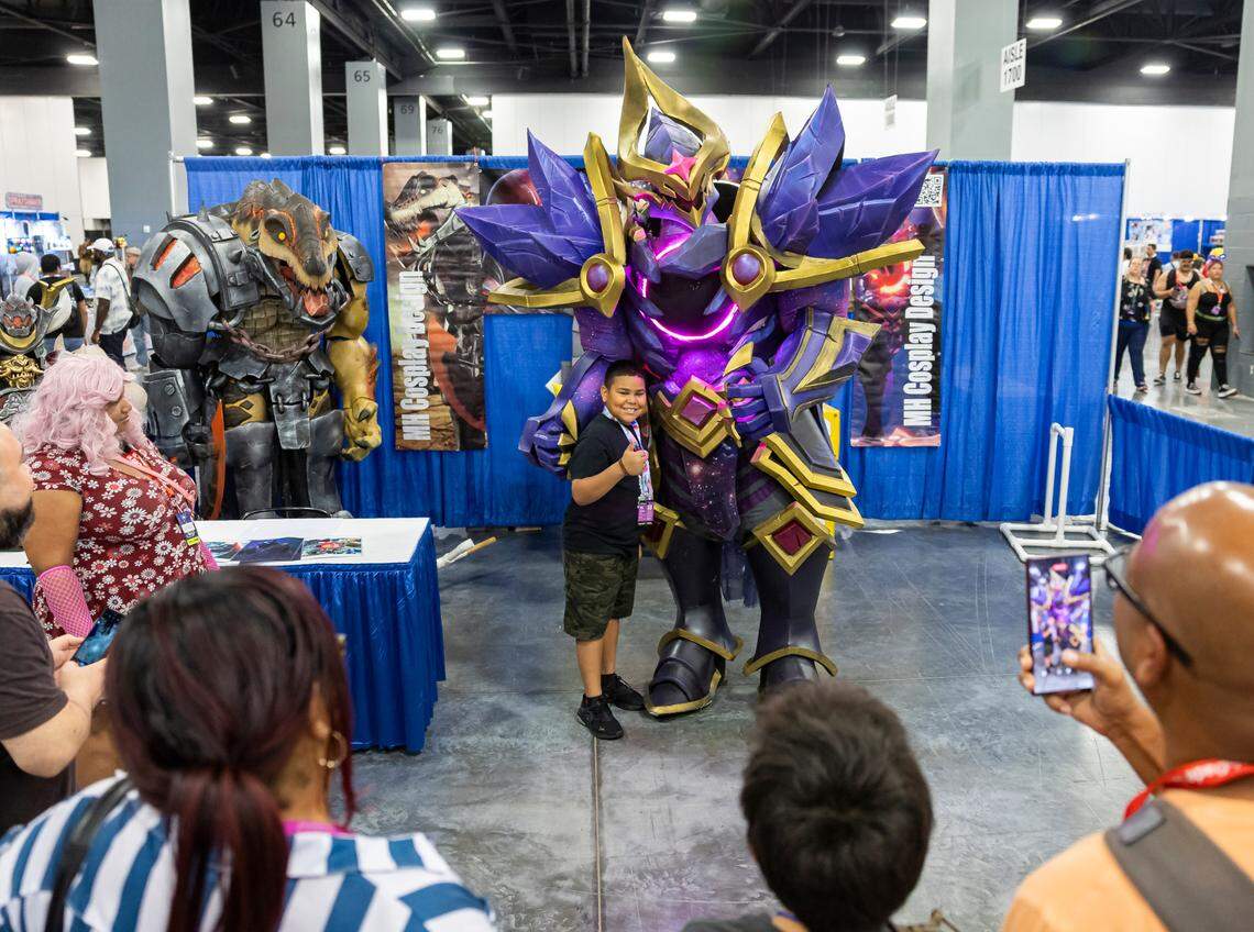 Matthew Harden, 34, takes photos with attendees while cosplaying as Dark Star Mordekaiser from League of Legends during Florida Supercon 2024 at the Miami Beach Convention Center on Saturday, July 13, 2024, in Miami Beach, Fla.