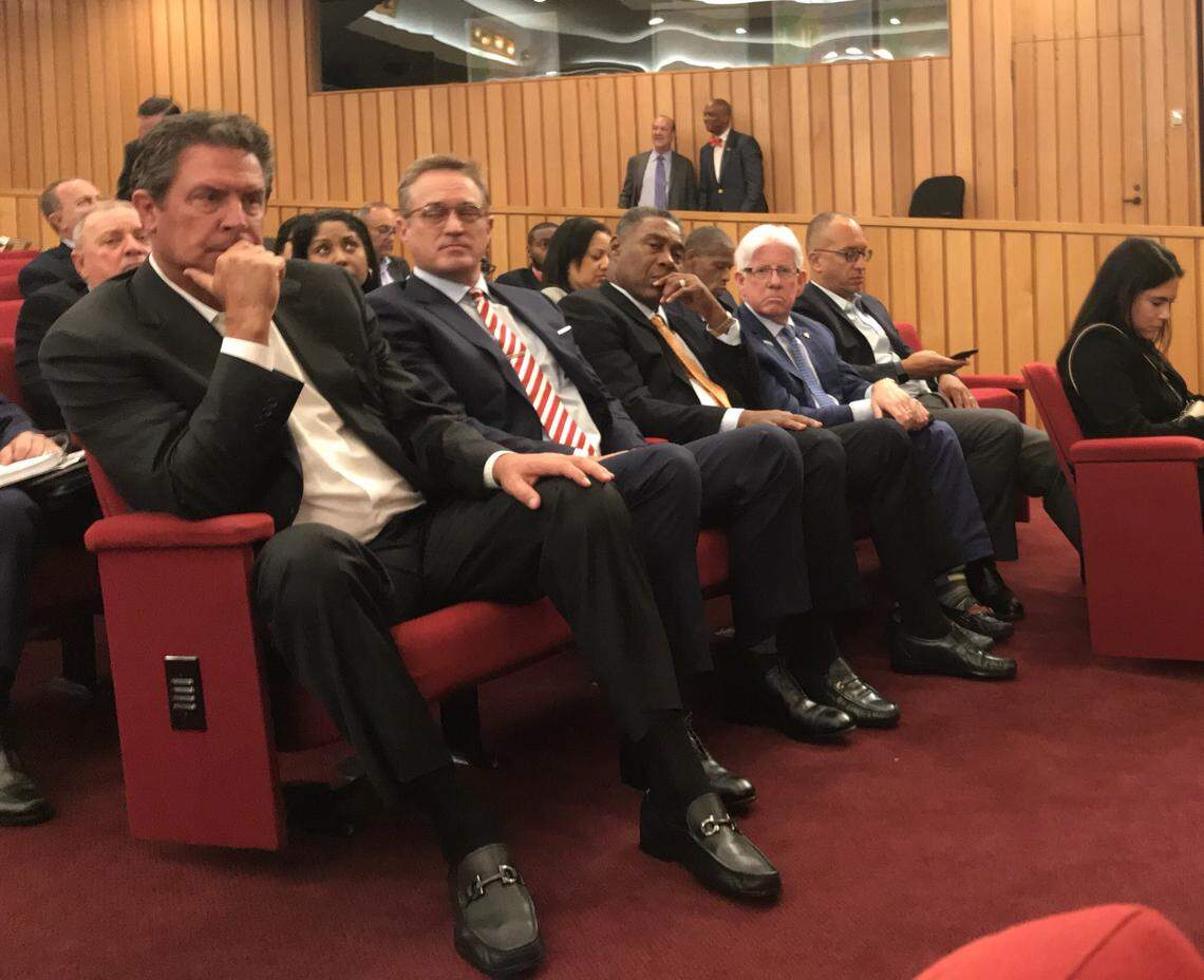 As Miami-Dade commissioners prepared to discuss an expanded subsidy deal for the Miami Dolphins connected to a new $75 million training facility in Miami Gardens, team luminaries, executives and supporters sat in the second row of the chambers. From left: Dan Marino, team CEO Tom Garfinkel, team senior vice president Nat Moore, Miami-Dade tourism director Bill Talbert, and team general counsel Myles Pistorius.