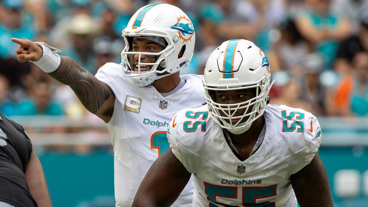 Miami Dolphins quarterback Tua Tagovailoa (1) calls a play as Miami Dolphins guard Aaron Brewer (55) blocks in the first half of their NFL game against the Las Vegas Raiders at Hard Rock Stadium on Sunday, Nov. 17, 2024, in Miami Gardens, Fla