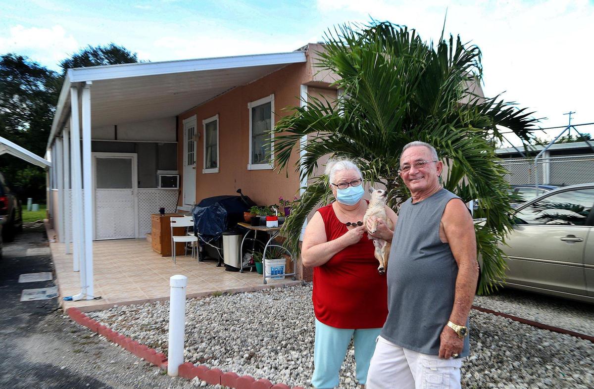 Maria Blanco and Pedro Freyre, with their chihuahua named Coqui, at their home at the Honey Hill Mobile Home Park in Miami Gardens, on Friday, September 11, 2020.