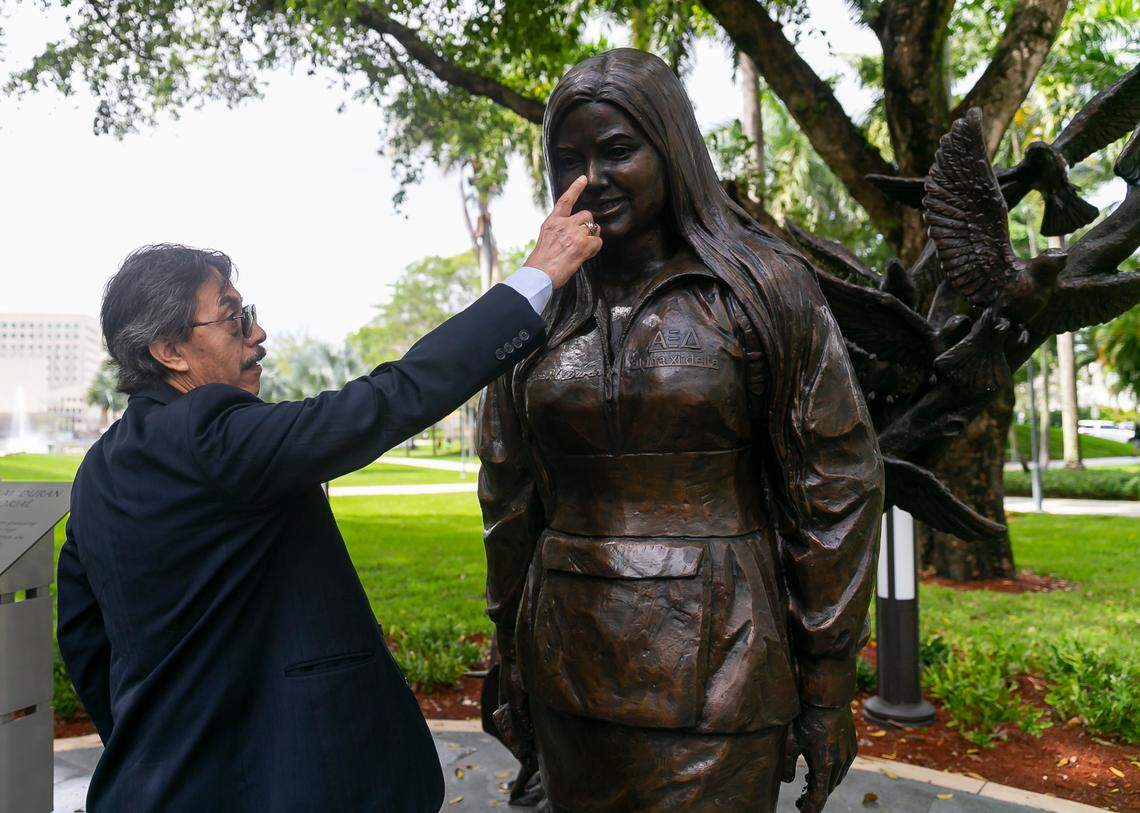 Orlando Duran, the father of Alexa Duran, touches the nose of a bronze statue of his daughter during the unveiling of the memorial at Florida International University in Miami, on the fourth anniversary of the FIU bridge collapse on Tuesday, March 15, 2022. When she was alive, he would poke at her nose.