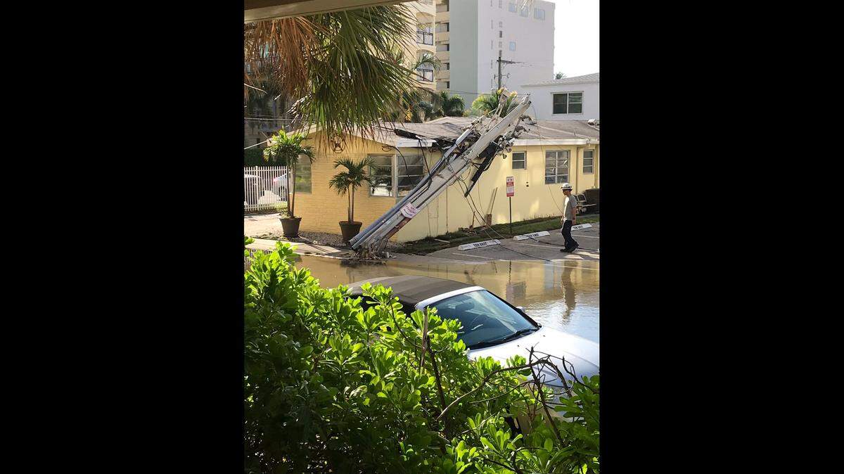 A garbage truck has knocked down a power pole, sending it crashing into a duplex and leaving more than a hundred people without power in Hollywood.