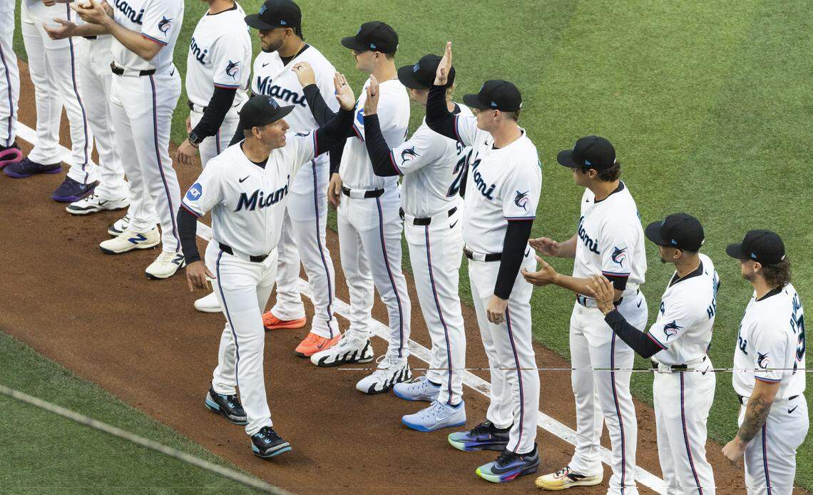 Miami Marlins manager Clayton McCullough (86) greets his teammates during the opening ceremonies of their MLB game against the Colorado Rockies at loanDepot park on Friday, March 27, 2026, in Miami, Fla.