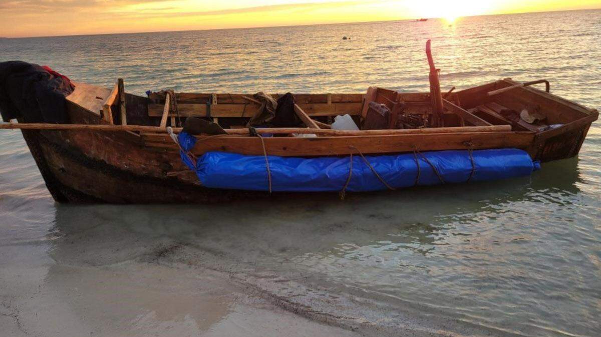 A wooden boat is beached on the shores of the Middle Florida Keys city of Marathon Monday, Nov. 29, 2021. U.S. Border Patrol agents say the vessel carried 18 people from Cuba.