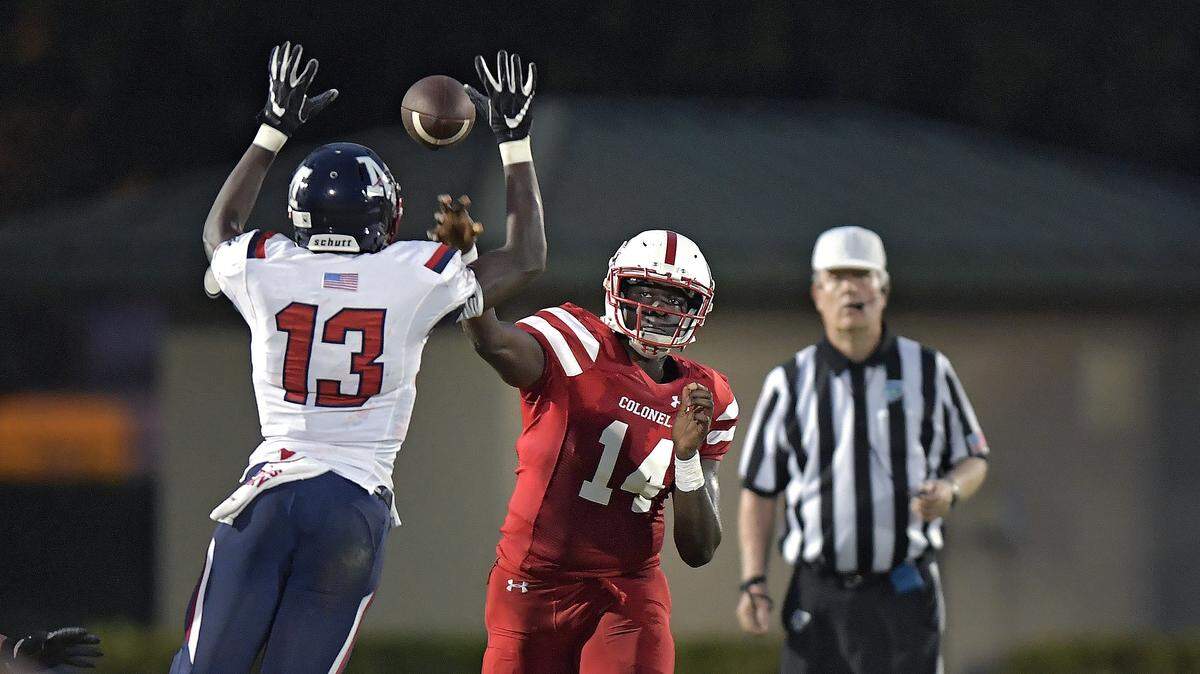 Plantation quarterback Gerard Nesbitt throws the ball into the hands of Miramar’s Xavier Clarke during the first half of their game, Friday, Sept. 14, 2018.