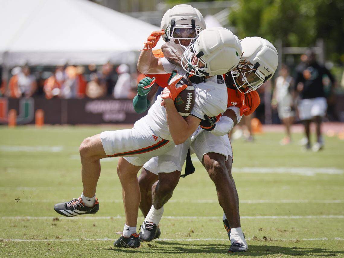 Miami Hurricanes wide receiver Cooper Barkate (18) is tackled by Defensive Back Conrad Hussey (38) during UM’s spring football game at Cobb Stadium on the University of Miami campus in Coral Gables, Florida, on Saturday, April 18, 2026.