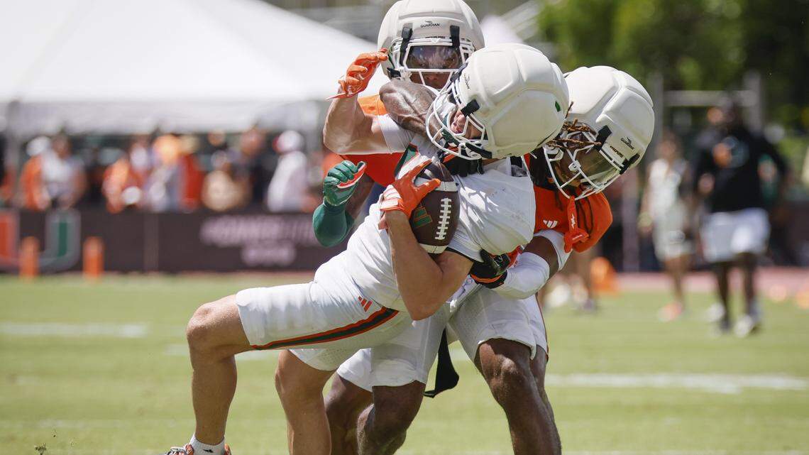 Miami Hurricanes wide receiver Cooper Barkate (18) is tackled by Defensive Back Conrad Hussey (38) during UM’s spring football game at Cobb Stadium on the University of Miami campus in Coral Gables, Florida, on Saturday, April 18, 2026. 