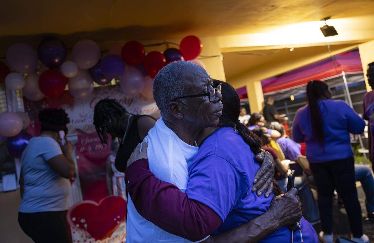 Donovan Broadbelt, husband of the late Doreen Richards Broadbelt, receives a hug during a vigil at his home on Tuesday, Sept. 9, 2025, in Miami Gardens, Fla. Broadbelt, 71, was walking to her job at Walmart when a dog attacked and fatally mauled her near her home on Labor Day, police said.