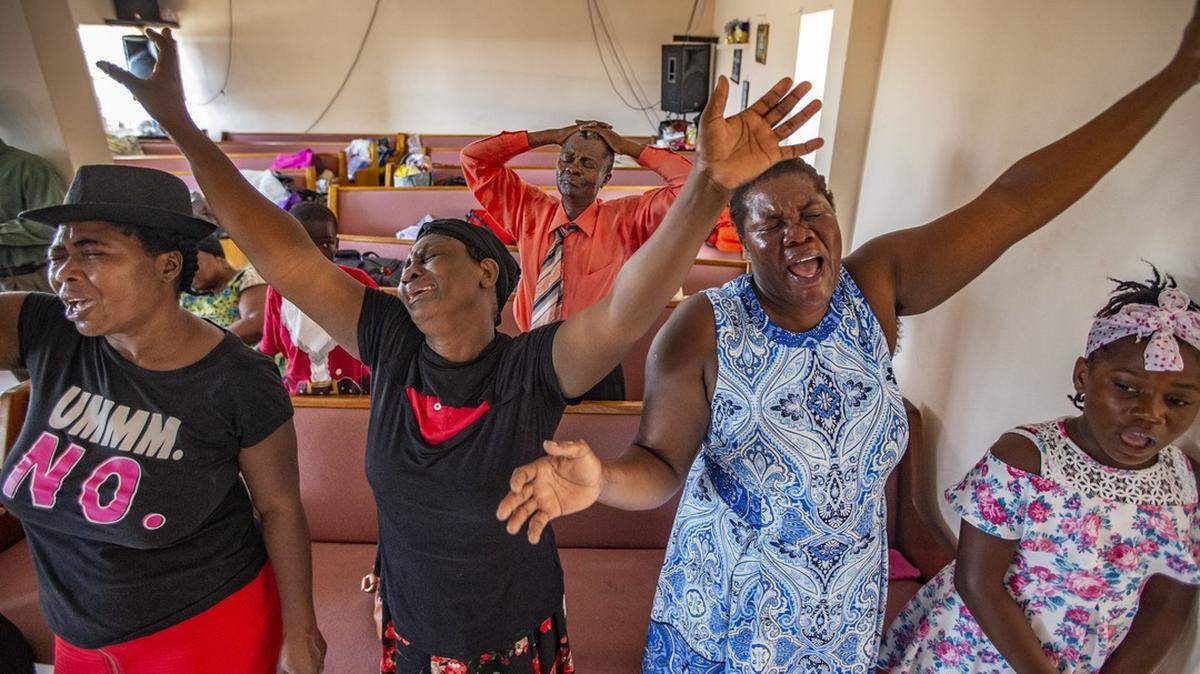 Haitian Bahamians Delanie Celus, Dejanie Louisaint, Adeline Pierre and Nadine Gene, left to right, sing during service at First Beraca Baptist Church in Marsh Harbour after Hurricane Dorian’s devastation.