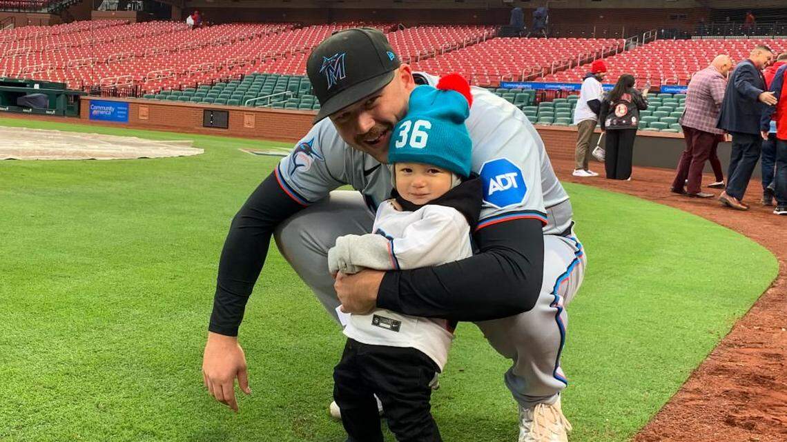 Miami Marlins infielder with his son, Brooks, after the team’s game against the St. Louis Cardinals on Thursday, April 4, 2024, at Busch Stadium in St. Louis, Missouri.