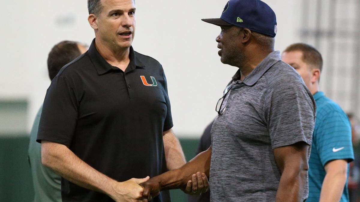 Miami Hurricanes football coach Mario Cristobal talks with former Cane player Alonzo Highsmith as graduating seniors perform for scouts at Pro Day at the University of Miamis Carol Soffer Indoor Practice Facility in Coral Gables on Wednesday, March 30, 2022 ahead of the 2022 NFL Draft.