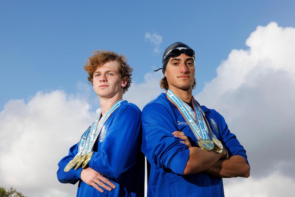Dylan Ferguson, left, and George Gonzalez, seniors at Braddock on the boys swim team, pose with their medals from the state championship for the All-Dade Players of the Year photo on Tuesday, Dec. 17, 2024, at AD Barnes Park in Miami.