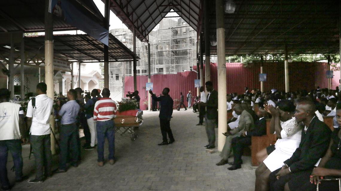 People pray inside Sacred Heart Catholic Church in Port-au-Prince during a funeral for five people killed during anti-government protests in Haiti.