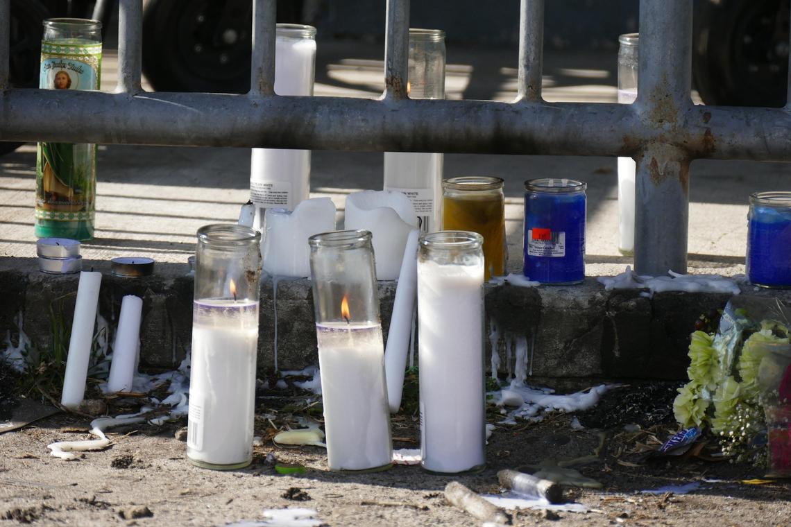 Candles are lit at a memorial following a deadly afternoon shooting Sunday, April 8, 2018, in Liberty Square in Miami that claimed the lives of 17-year-old Kimson Green and Rickey Dixon, 18. Two other young men were also shot.