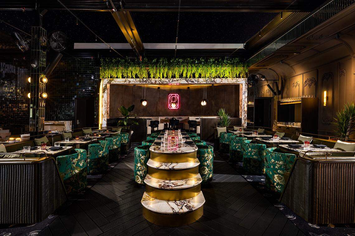 The main dining area of Giselle features greenery and wood paneling and can seat parties of any size, from intimate tables for two to tables for 10.