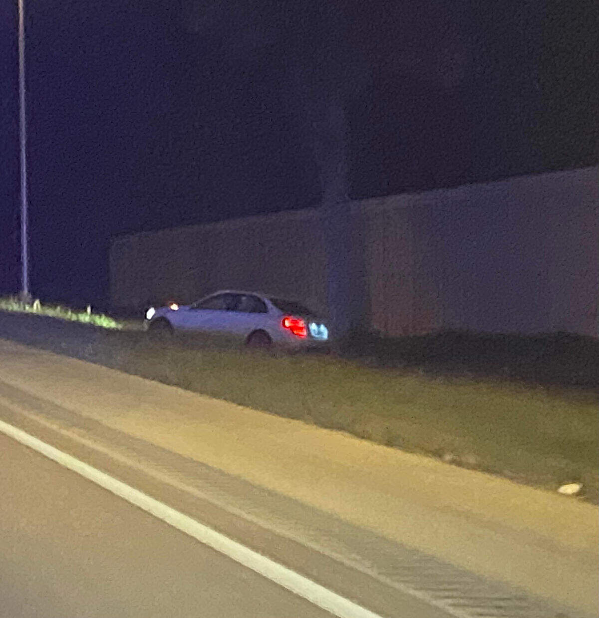 A white sedan is parked on the side of Florida’s Turnpike around mile marker 8 Tuesday morning, June 11, 2024. Police say the driver of that car was shot by another driver.
