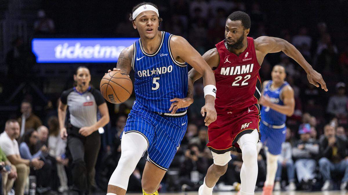 Orlando Magic forward Paolo Banchero (5) drives the ball as Orlando Magic forward Franz Wagner (22) defends in the second half of their NBA game at Kaseya Center on Jan. 28, 2026, in Miami.