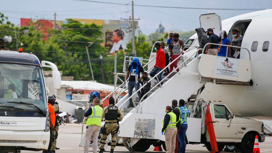 FILE - Haitians who were deported from the United States deplane at the Toussaint Louverture International Airport, in Port au Prince, Haiti, Sept. 19, 2021. More than 20,000 Haitians have been deported from the U.S. in 2022, as thousands more continue to flee Haiti.