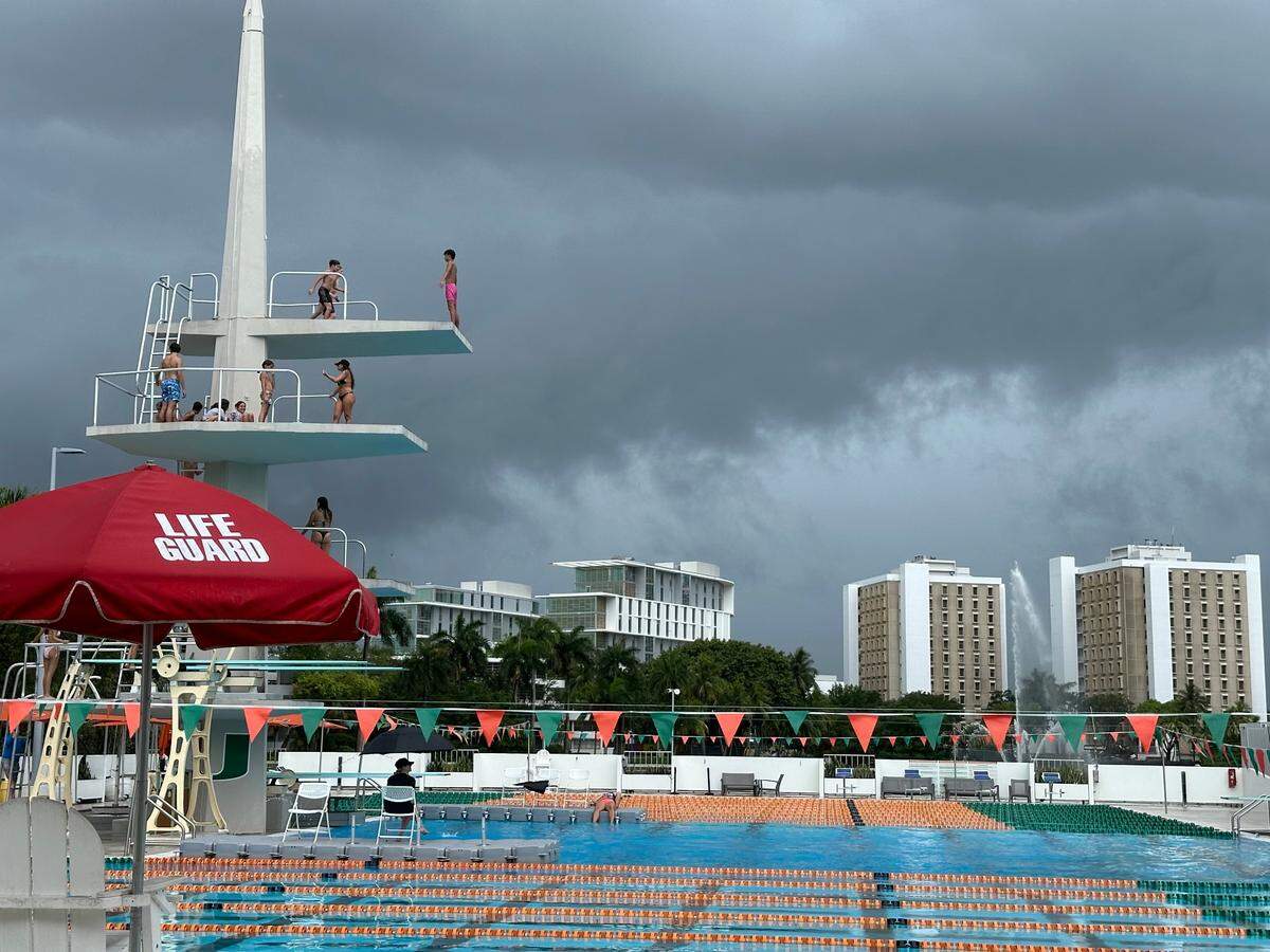 Kids attending University of Miami’s summer dive camp on Friday, June 14, 2024, get a few more leaps off the 10-meter diving tower before the clouds burst and lightning detectors blared.