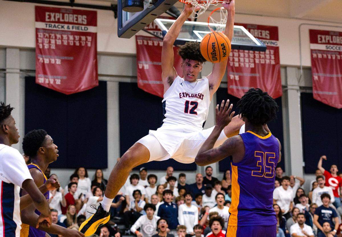 Explorers power forward Cameron Boozer (12) dunks over Camden forward Dasear Haskins (35) during the fourth period of a high school basketball game at Christopher Columbus High School in Miami, Florida, on Wednesday, January 4, 2023.