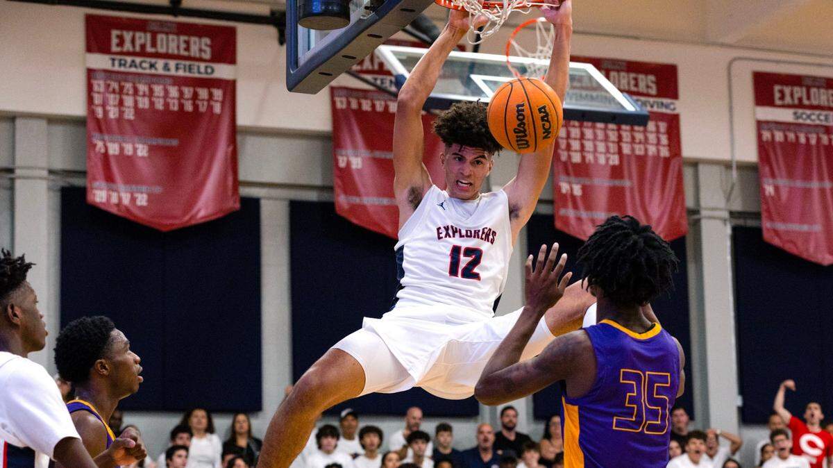 Explorers power forward Cameron Boozer (12) dunks over Camden forward Dasear Haskins (35) during the fourth period of a high school basketball game at Christopher Columbus High School in Miami, Florida, on Wednesday, January 4, 2023.