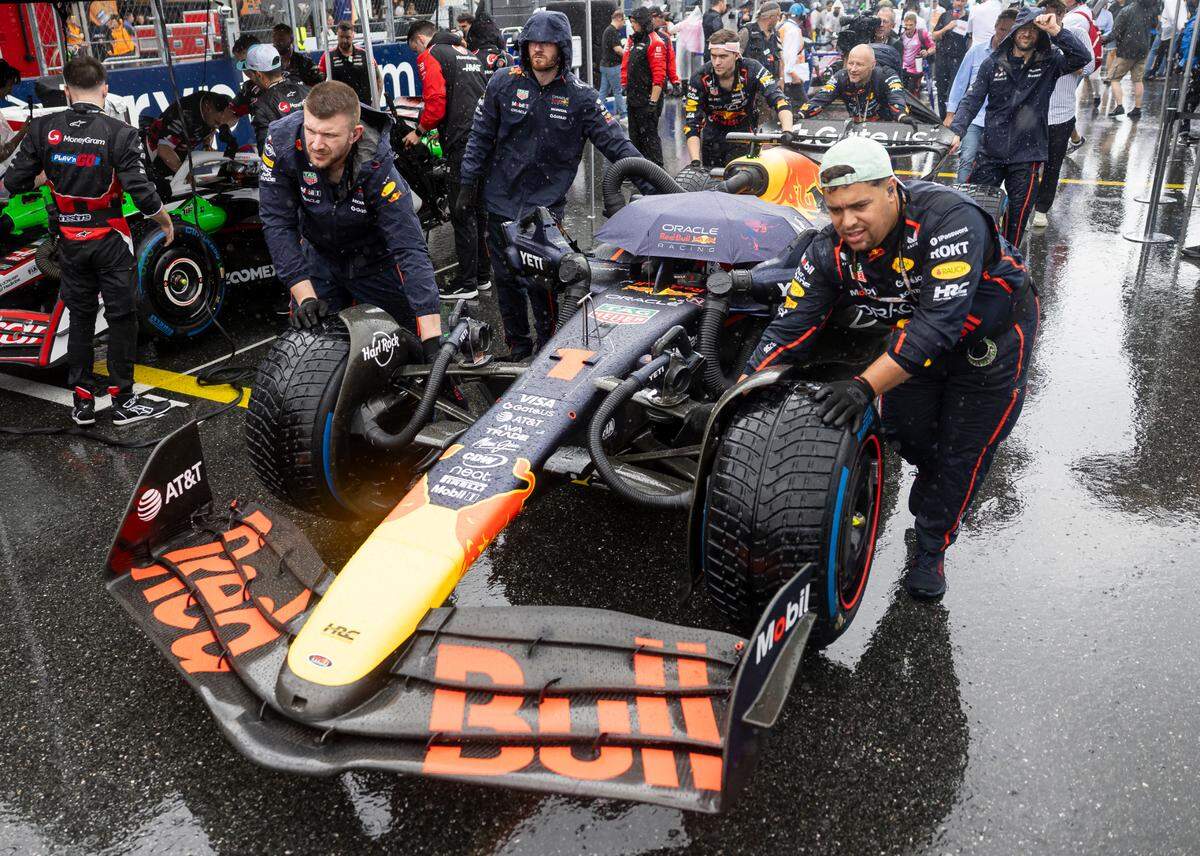 Red Bull Racing crew members push Max Verstappen of Netherlands and his car to the starting line before his Sprint race on the second day of the Formula One Miami Grand Prix at the Miami International Autodrome on Saturday, May 3, 2025, in Miami Gardens, Fla.