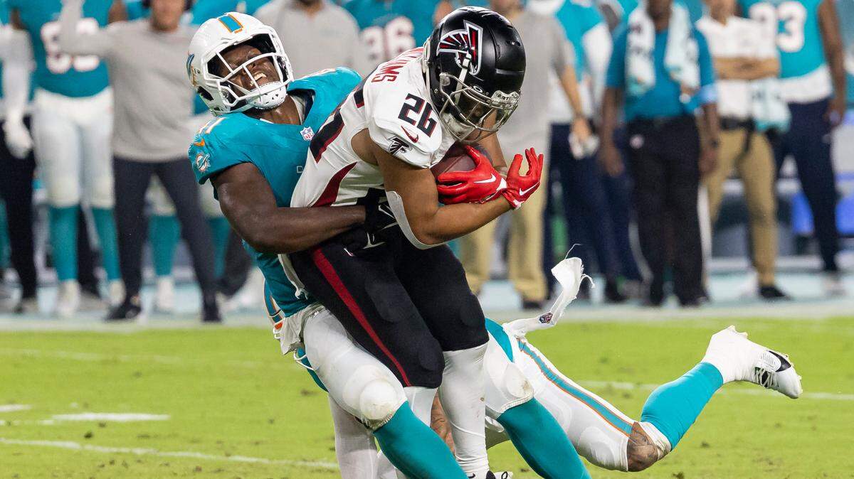 Miami Dolphins linebacker Channing Tindall (41) tackles Atlanta Falcons running back Avery Williams (26) in the second quarter of their NFL pre-season football game at Hard Rock Stadium on Friday, Aug. 9, 2024, in Miami Gardens, Fla.A Dol