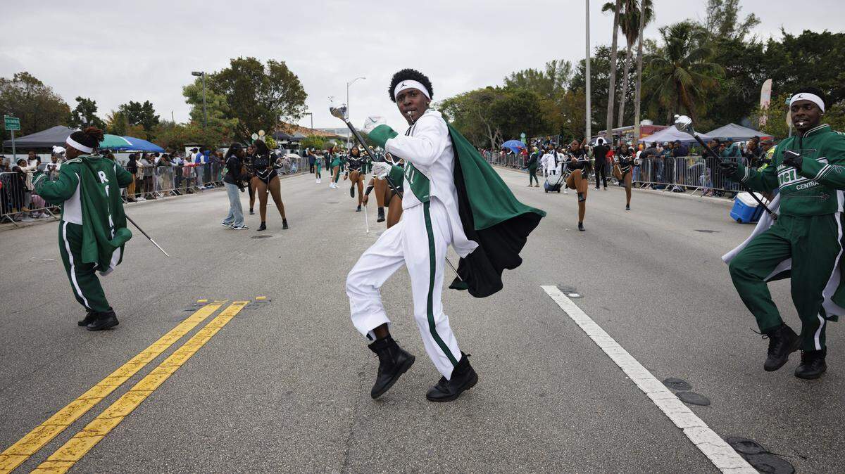 Trayvon Early, head drum major for Miami Central, center, leads the Miami Central High School band during the Dr. Martin Luther King Jr. Day parade on Monday, Jan. 20, 2025, in Liberty City in Miami, Fla. 